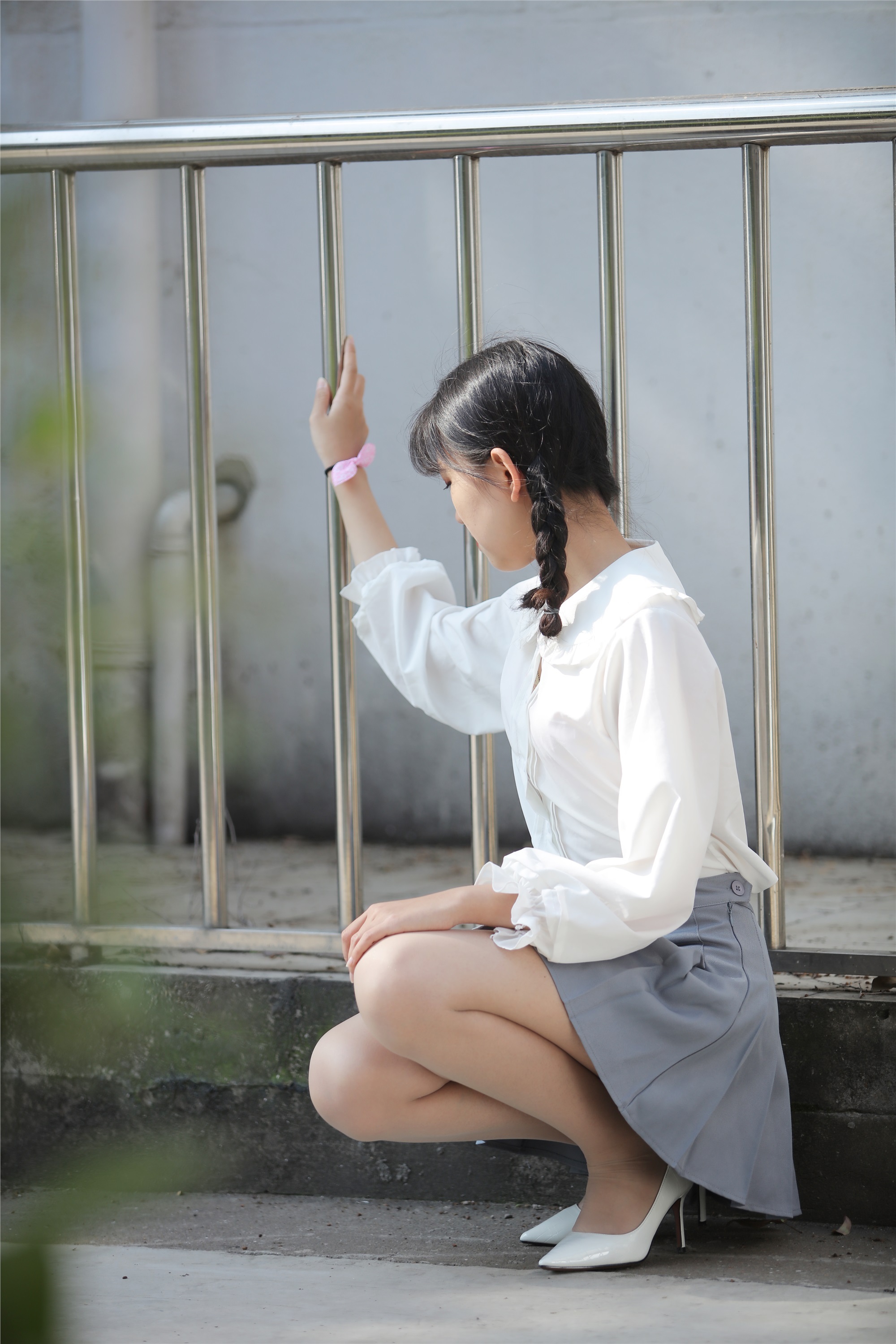 Little Orange with ponytail and white pleated skirt